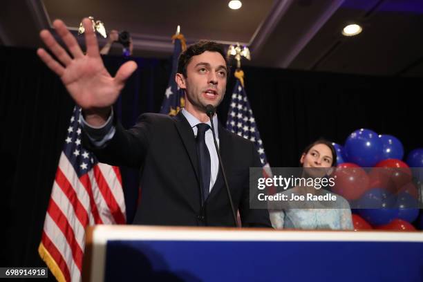 Democratic candidate Jon Ossoff delivers a concession speech as his fiancee, Alisha Kramer, listens during his election night party being held at the...