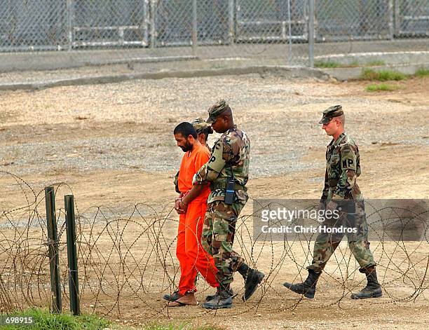 Marines transport a detainee in Camp X-Ray February 6, 2002 in Guantanamo Bay, Cuba. Many of the 156 Al-Qaeda or Taliban detainees are transported...
