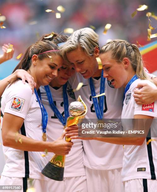 United States' Alex Morgan, Lauren Holiday, Abby Wambach and Whitney Engen celebrate winning the World Cup following the FIFA Women's World Cup...