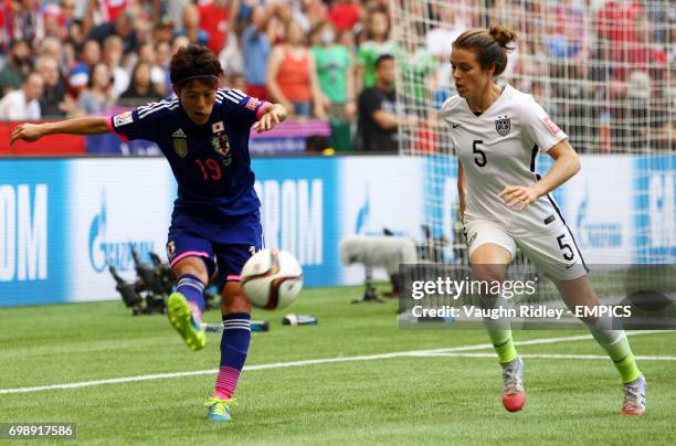 Japan's Saori Ariyoshi clears the ball under pressure from United States Kelley O'Hara during the FIFA Women's World Cup Canada 2015 Final match...