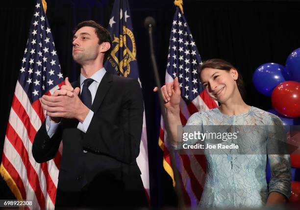 Democratic candidate Jon Ossoff and and his fiancee, Alisha Kramer, prepare to exit after he gave a concession speech speak during his election night...