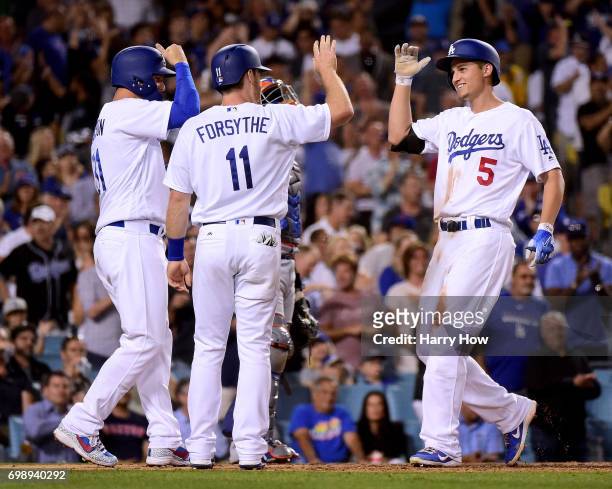 Corey Seager of the Los Angeles Dodgers reacts to his three run homerun with Logan Forsythe and Joc Pederson, his third homerun of the game, to take...
