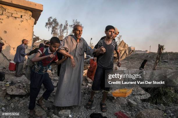 Hundreds of exhausted and panicked civilians flee Bab Sinjar, Zanjili and Abi Tamam, the 3 districts on the north side of Mosul's Old City, which is...