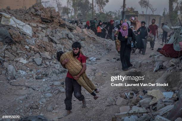 Hundreds of exhausted and panicked civilians flee Bab Sinjar, Zanjili and Abi Tamam, the 3 districts on the north side of Mosul's Old City, which is...