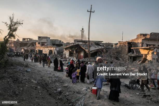 Hundreds of exhausted and panicked civilians flee Bab Sinjar, Zanjili and Abi Tamam, the 3 districts on the north side of Mosul's Old City, which is...