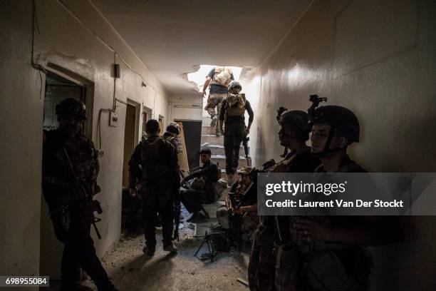 Commando of 7 men of the 1st brigade of the ISOF fights Daesh, house by house, to take control of Al Saha, one of the last districts of Mosul be...