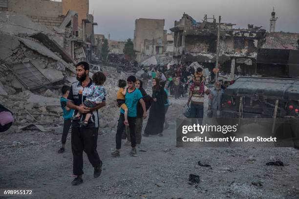 Hundreds of exhausted and panicked civilians flee Bab Sinjar, Zanjili and Abi Tamam, the 3 districts on the north side of Mosul's Old City, which is...