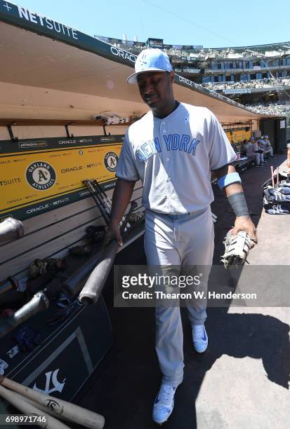 Chris Carter of the New York Yankees walks into the dugout to place his bats in the rack prior to the start of the game against the Oakland Athletics...