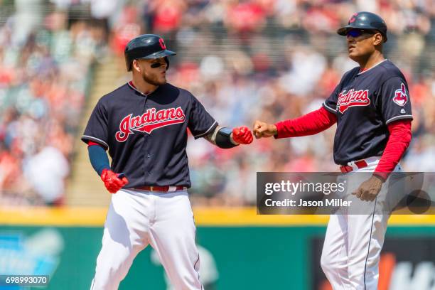 Roberto Perez of the Cleveland Indians celebrates with first base coach Sandy Alomar Jr. #15 after Perez reaches first during the third inning...