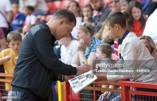 West Ham United manager Slaven Bilic signs autographs