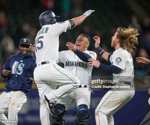 Carlos Ruiz, second from left, of the Seattle Mariners and Ben Gamel, right, of the Seattle Mariners celebrate with Kyle Seager of the Seattle...