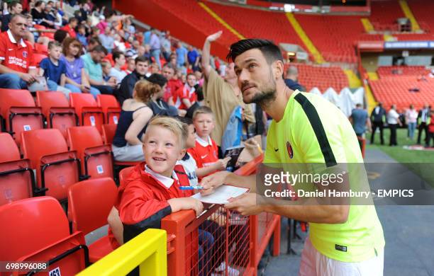 Charlton Athletic's Johnnie Jackson signs autographs for fans.