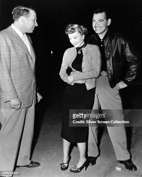Actors Clark Gable and Barbara Stanwyck enjoying a laugh on the set of the film 'To Please a Lady', 1950.