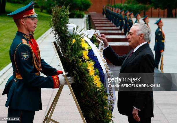 Brazil's President Michel Temer takes part in a wreath-laying ceremony at the Tomb of the Unknown Soldier by the Kremlin wall in Moscow on June 21,...