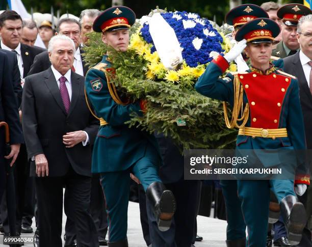 Brazil's President Michel Temer takes part in a wreath-laying ceremony at the Tomb of the Unknown Soldier by the Kremlin wall in Moscow on June 21,...