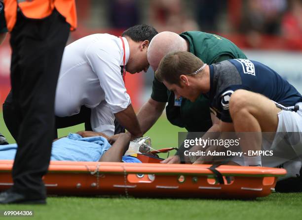 Tottenham Hotspur's Nathan Oduwa has a neck brace put on after falling heavily under a tackle