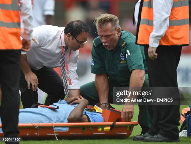 Tottenham Hotspur's Nathan Oduwa has a neck brace put on after falling heavily under a tackle