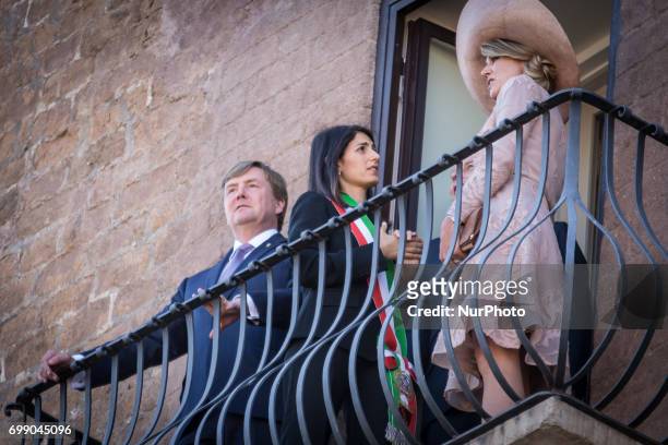 King Willem-Alexander and Queen Maxima of Netherlands stand on the balcony at Rome City Hall during a visit with Rome's mayor Virginia Raggi on June...