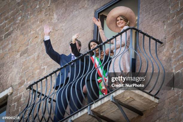 King Willem-Alexander and Queen Maxima of Netherlands stand on the balcony at Rome City Hall during a visit with Rome's mayor Virginia Raggi on June...