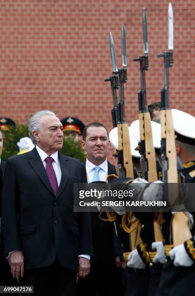 Brazil's President Michel Temer watches honour guards passing by as he takes part in a wreath-laying ceremony at the Tomb of the Unknown Soldier by...