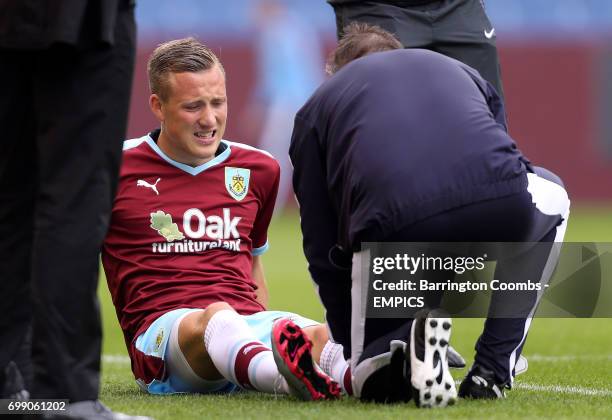 Burnley's Fredrik Ulvestad is treated for an injury