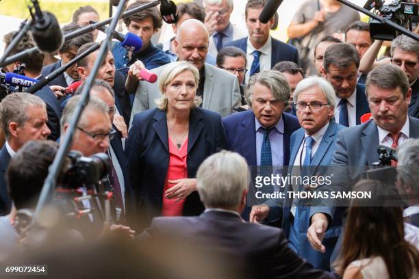 French far-righ Front National party's newly elected Members of Parliament Marine Le Pen , Gilbert Collard and Louis Aliot escorted by bodyguard...