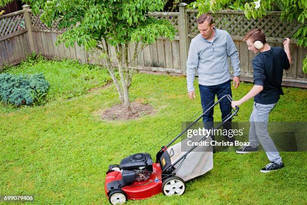 learning to cut the grass - dad mowing stock pictures, royalty-free photos & images