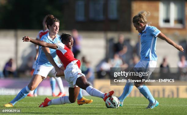 Arsenal Ladies's Dan Carter and Manchester City's Jennifer Beattie and Isobel Christiansen battling for the ball