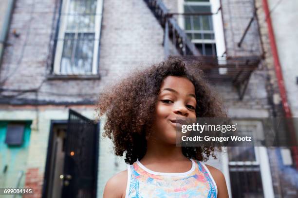 portrait of smirking mixed race girl - sourire narquois photos et images de collection