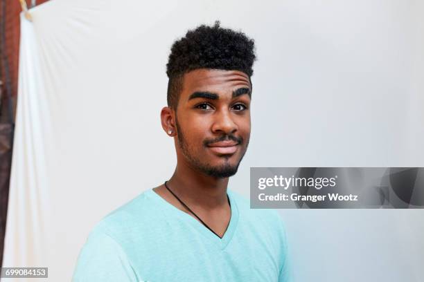 portrait of smiling black man raising eyebrow - raised eyebrows stockfoto's en -beelden