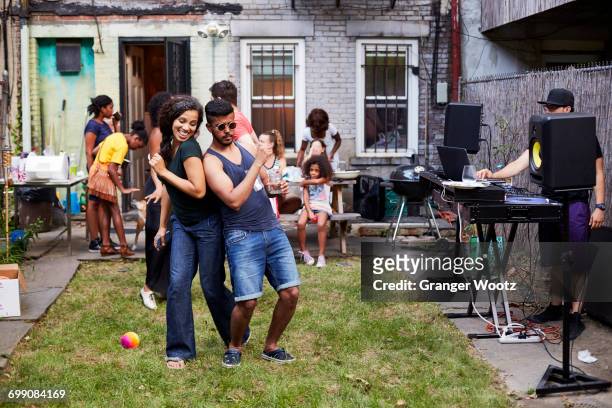 couple dancing at backyard party - girl dj stock-fotos und bilder