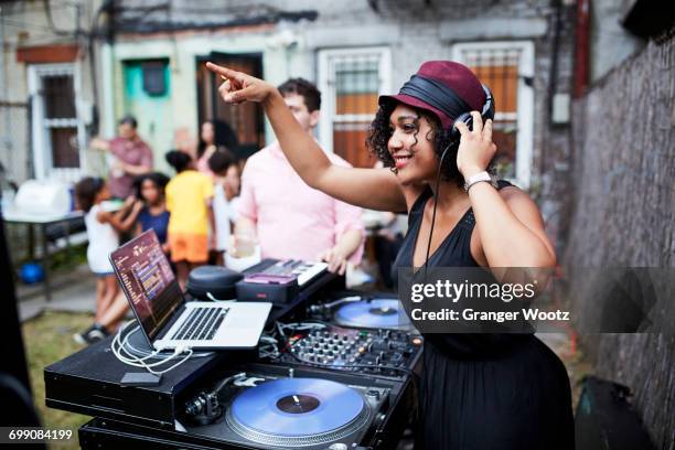 mixed race dj playing music at party in backyard - dj booth bildbanksfoton och bilder