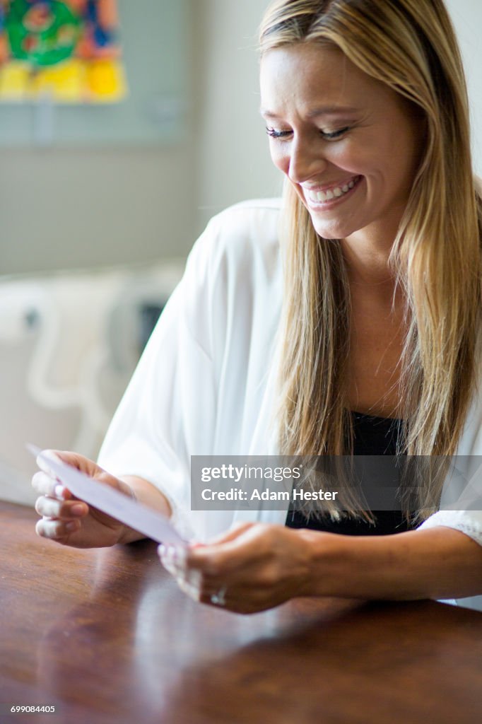 Caucasian woman reading invitation