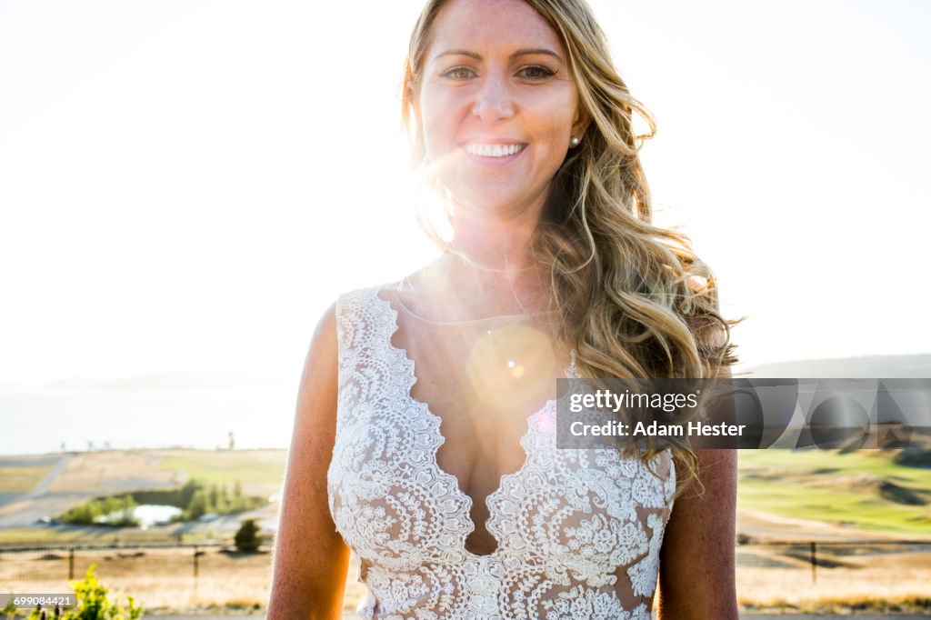 Caucasian bride smiling on sunny day