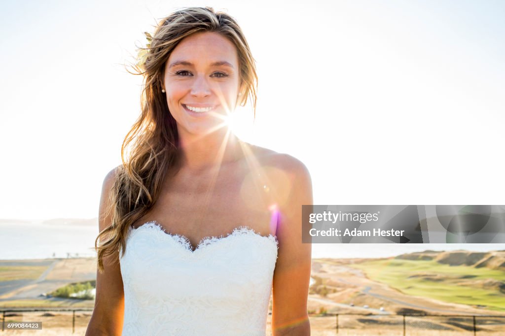 Caucasian bride smiling on sunny day