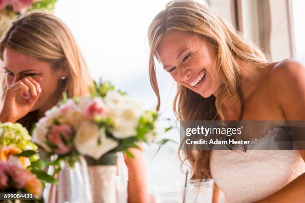 caucasian brides laughing at table - teardrop stockfoto's en -beelden