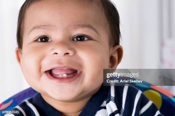 smiling hispanic baby boy - baby tooth stock-fotos und bilder