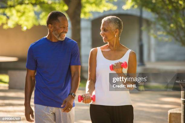 black couple walking in park - african american couple walking park ストックフォトと画像