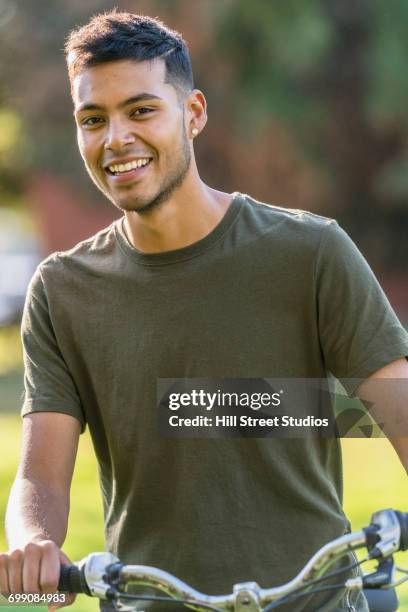 hispanic man posing on bicycle - caldwell idaho stockfoto's en -beelden