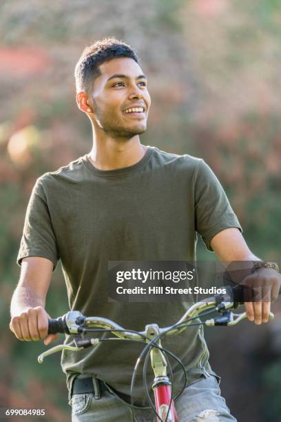 hispanic man riding bicycle - コールドウェル市 ストックフォトと画像