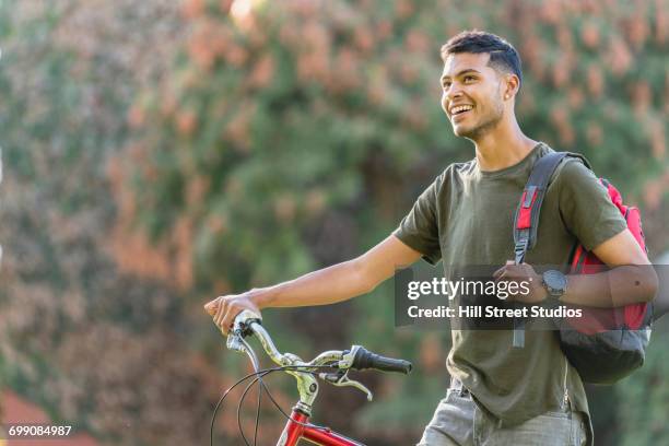 hispanic man with bicycle and backpack - caldwell idaho stock pictures, royalty-free photos & images