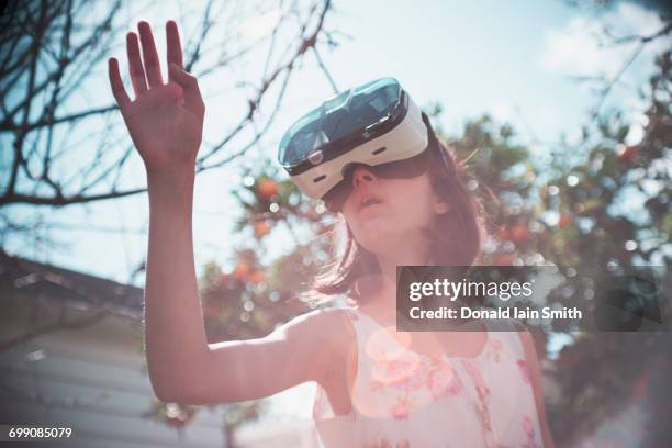 mixed race girl using virtual reality goggles outdoors - palmerston north nz bildbanksfoton och bilder