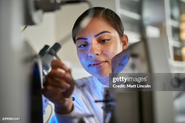 scientists placing object on scientific equipment using tweezers - medical student stock pictures, royalty-free photos & images