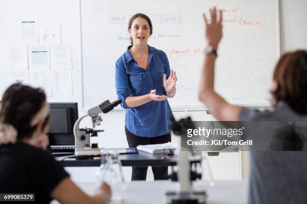 students questioning professor in classroom - science teacher stock pictures, royalty-free photos & images