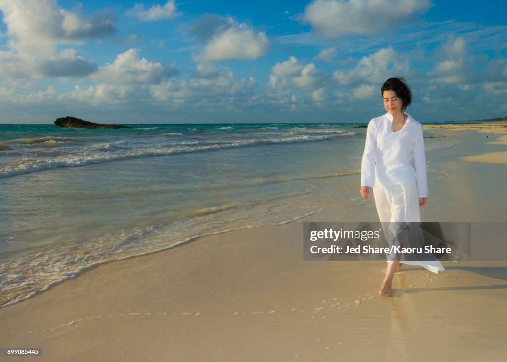 Japanese woman walking on beach