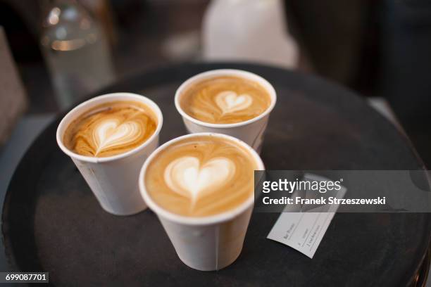 three takeaway cups of coffee with heart shaped tops - coffee heart stock pictures, royalty-free photos & images