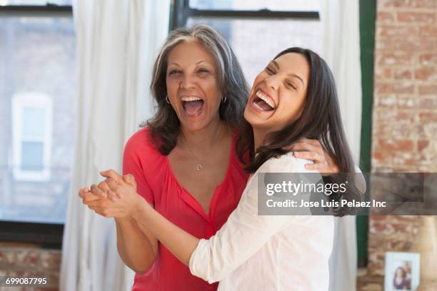 laughing hispanic women dancing - dancing funny carefree woman stock pictures, royalty-free photos & images