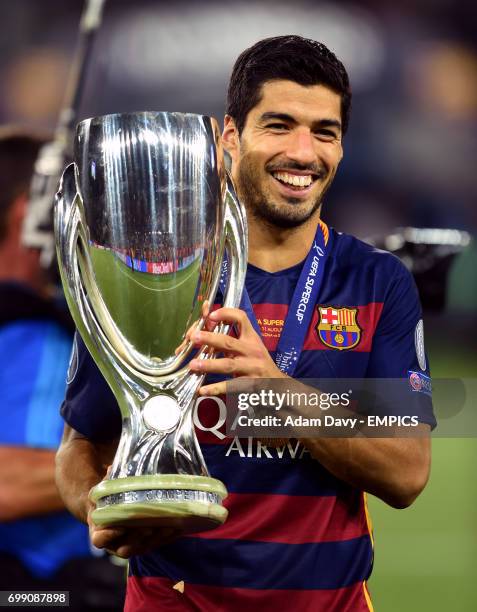 Barcelona's Luis Suarez poses with the trophy after winning the UEFA Super Cup