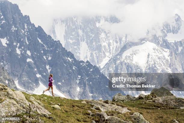 girl trail running in chamonix around the chesery lake - lake chesery stockfoto's en -beelden