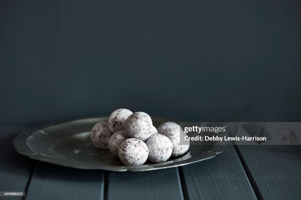 Chocolate and champagne truffles on silver plate